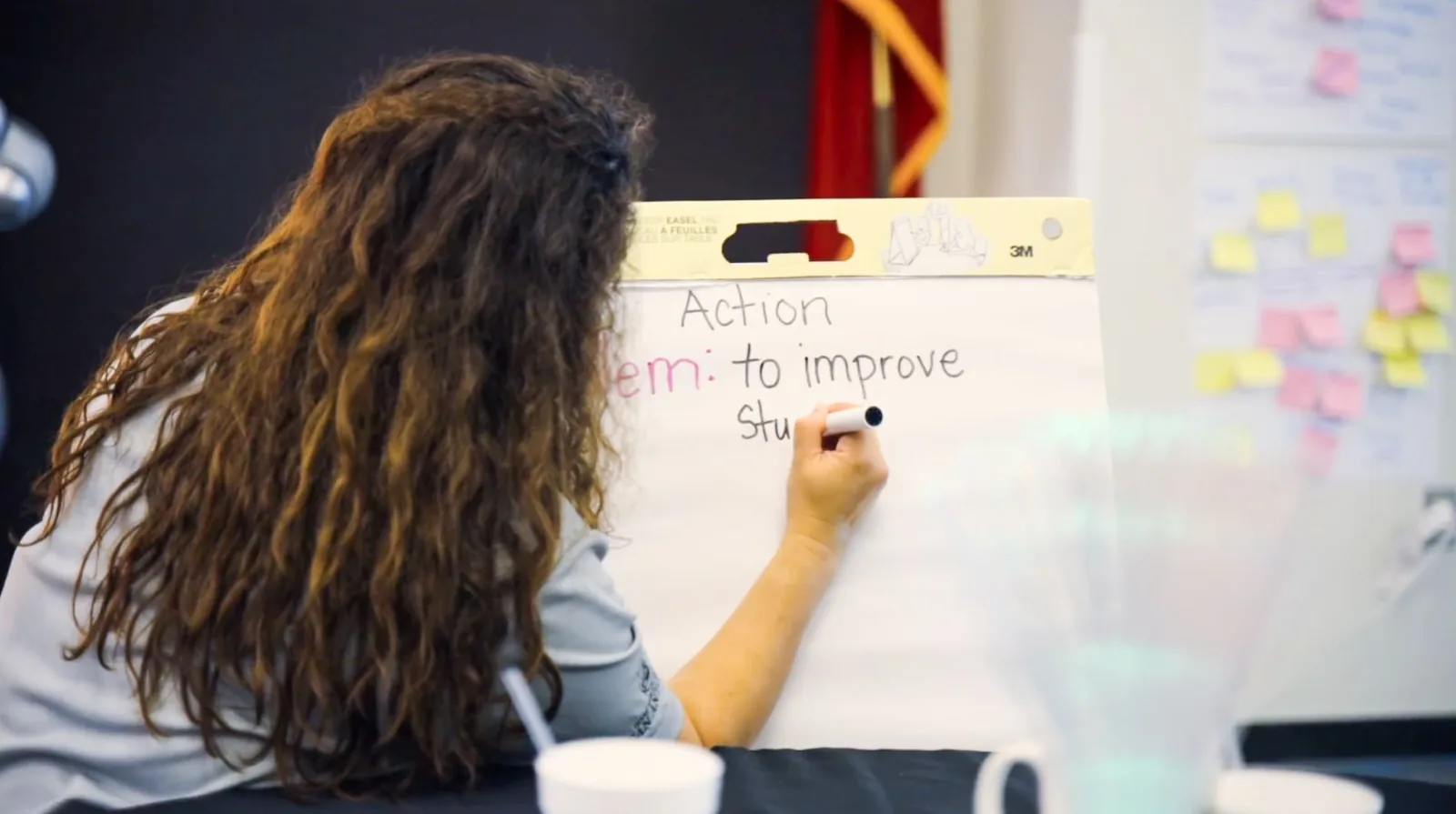 Educator writing an action plan on a flip chart